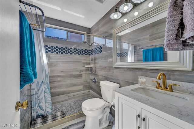 103 Trout Creek Ct, Las Vegas, NV 89123 - bathroom featuring tile walls, a tile shower, vanity, and toilet