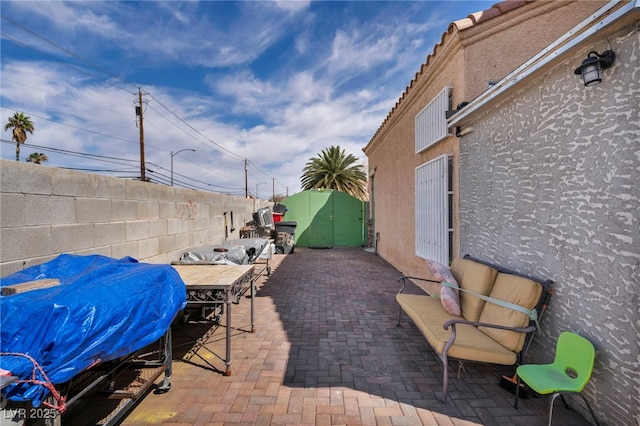 103 Trout Creek Ct, Las Vegas, NV 89123 - view of patio featuring a fenced backyard, outdoor dining area, and a grill