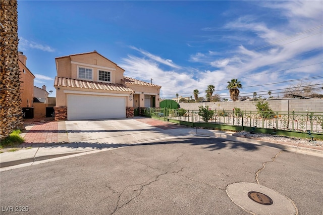 103 Trout Creek Ct, Las Vegas, NV 89123 - mediterranean / spanish house featuring concrete driveway, stucco siding, a tiled roof, fence, and a garage