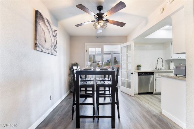 3120 S Eastern Ave Unit 6, Las Vegas, NV 89169 - dining room featuring light wood-style floors, baseboards, and a ceiling fan