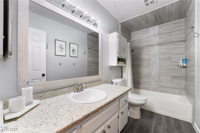 3120 S Eastern Ave Unit 6, Las Vegas, NV 89169 - bathroom with visible vents, vanity, shower / bath combo with shower curtain, wood finished floors, and toilet