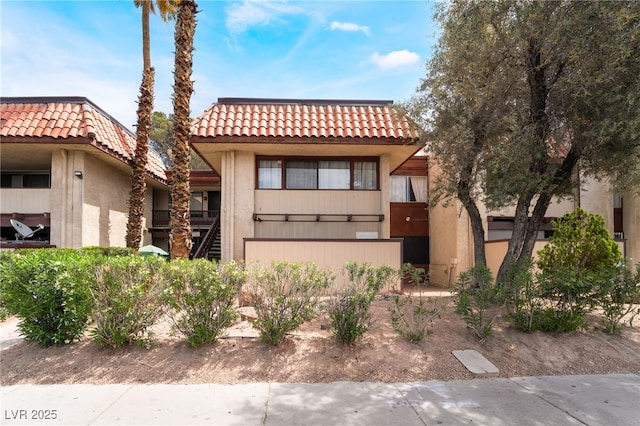 3120 S Eastern Ave Unit 6, Las Vegas, NV 89169 - view of front of house with stairs, stucco siding, and a tile roof