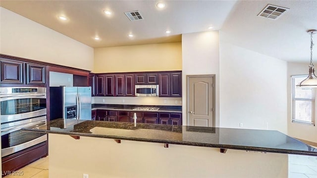 524 Blanche Ct, Henderson, NV 89052 - kitchen featuring a kitchen bar, visible vents, and appliances with stainless steel finishes