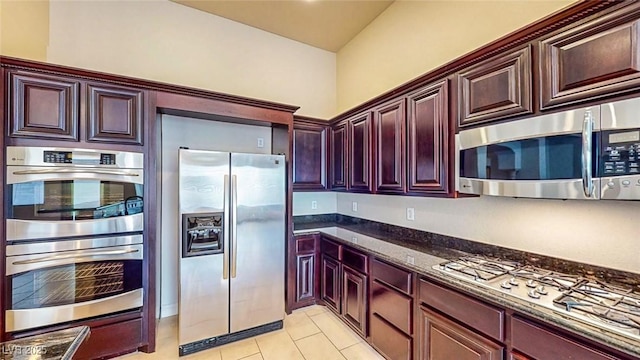 524 Blanche Ct, Henderson, NV 89052 - kitchen featuring appliances with stainless steel finishes, dark stone counters, dark brown cabinets, and light tile patterned floors