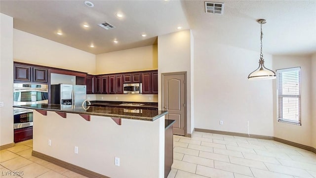524 Blanche Ct, Henderson, NV 89052 - kitchen featuring visible vents, stainless steel appliances, a kitchen breakfast bar, and light tile patterned floors