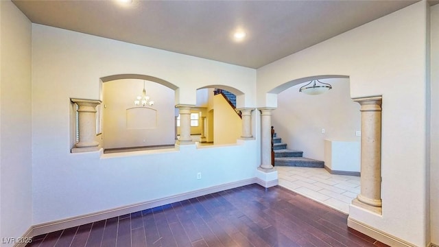 524 Blanche Ct, Henderson, NV 89052 - spare room featuring dark wood-type flooring, arched walkways, stairs, and baseboards