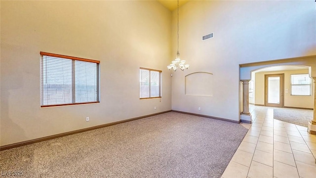 524 Blanche Ct, Henderson, NV 89052 - unfurnished room with a wealth of natural light, a notable chandelier, arched walkways, and decorative columns