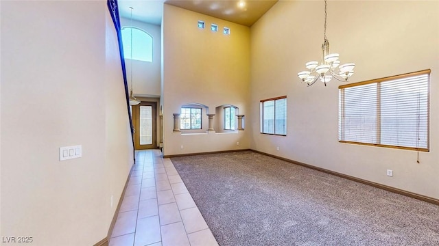 524 Blanche Ct, Henderson, NV 89052 - carpeted entrance foyer featuring tile patterned floors, a high ceiling, a chandelier, and baseboards