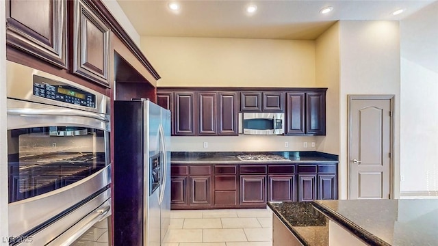 524 Blanche Ct, Henderson, NV 89052 - kitchen with light tile patterned floors, recessed lighting, stainless steel appliances, and dark stone counters