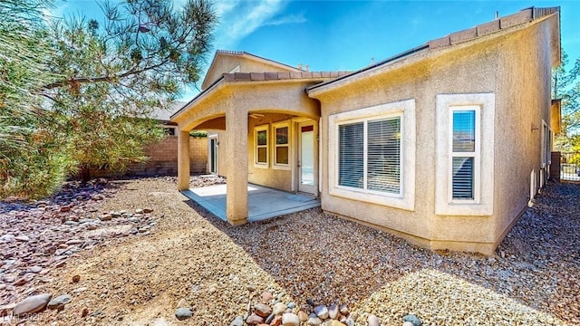 524 Blanche Ct, Henderson, NV 89052 - rear view of house with a patio, stucco siding, and fence