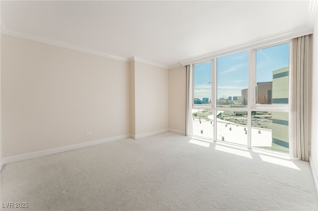 2877 Paradise Rd Unit 1806, Las Vegas, NV 89109 - empty room with carpet flooring, crown molding, a wall of windows, baseboards, and a city view