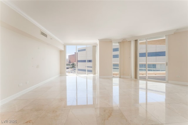 2877 Paradise Rd Unit 1806, Las Vegas, NV 89109 - spare room featuring crown molding, expansive windows, and baseboards