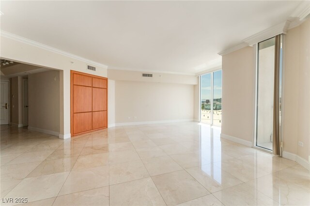 2877 Paradise Rd Unit 1806, Las Vegas, NV 89109 - spare room with ornamental molding, baseboards, and a wall of windows