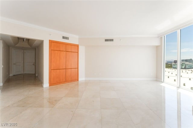 2877 Paradise Rd Unit 1806, Las Vegas, NV 89109 - unfurnished room with ornamental molding, baseboards, and a wall of windows