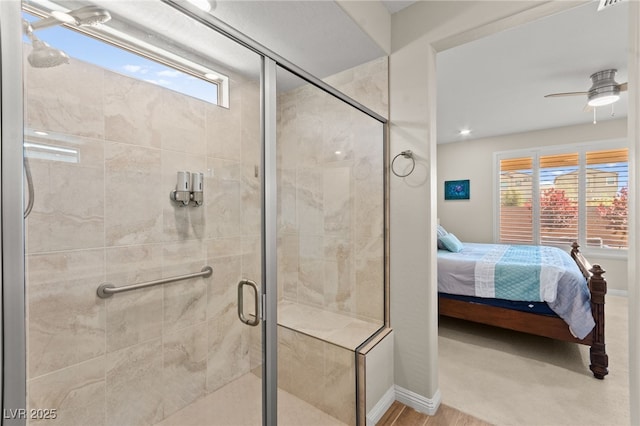 ensuite bathroom with connected bathroom, ceiling fan, a healthy amount of sunlight, and a stall shower