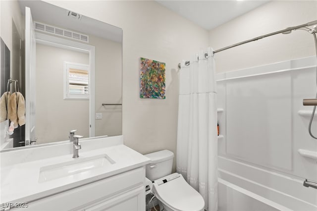 bathroom featuring shower / bath combo with shower curtain, visible vents, vanity, and toilet