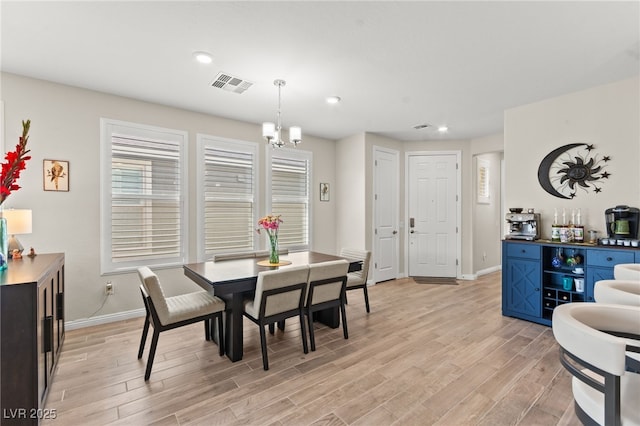 dining space with baseboards, light wood-style floors, visible vents, and recessed lighting