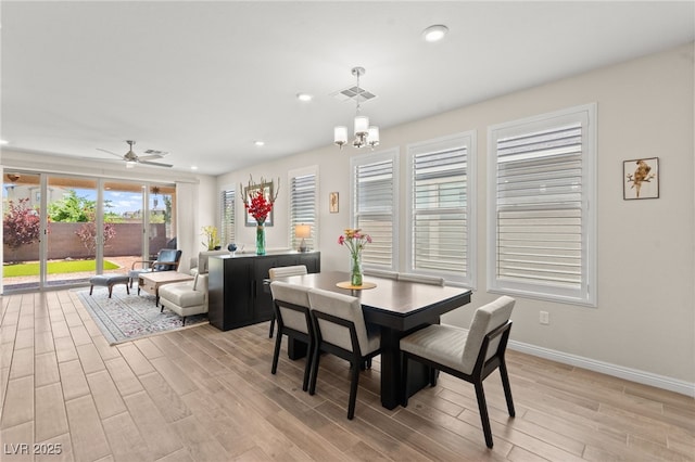 dining area featuring light wood finished floors, baseboards, visible vents, recessed lighting, and ceiling fan with notable chandelier