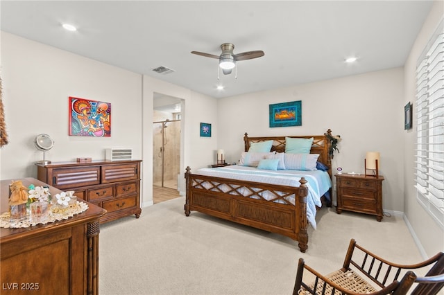 bedroom featuring light carpet, ensuite bathroom, and recessed lighting