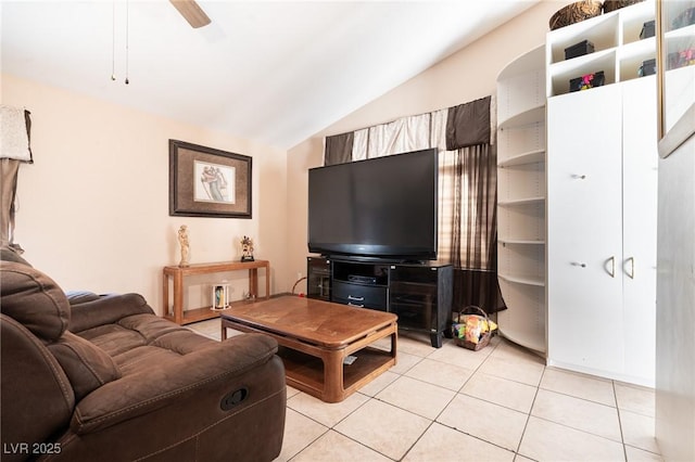 living area featuring lofted ceiling, ceiling fan, and light tile patterned floors