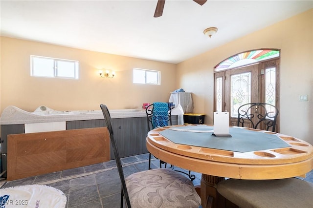 dining space with stone finish flooring and a ceiling fan
