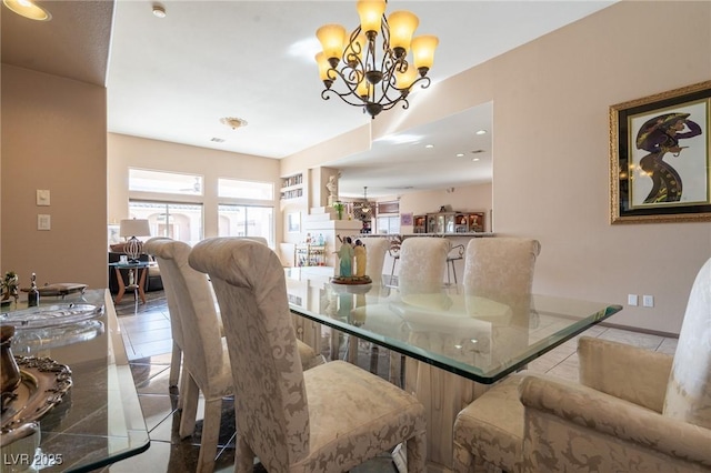 dining area with recessed lighting, an inviting chandelier, and tile patterned floors