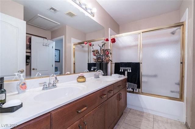 bathroom with visible vents, a sink, and double vanity