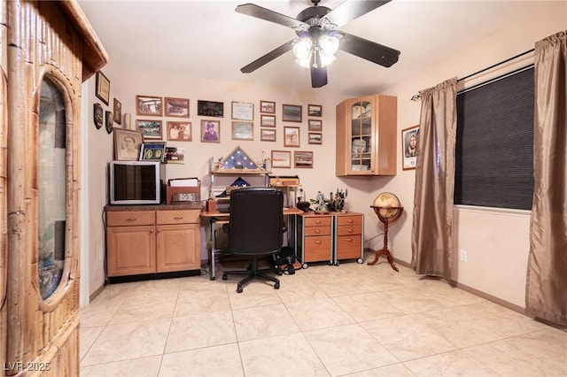 office with light tile patterned floors, ceiling fan, and baseboards