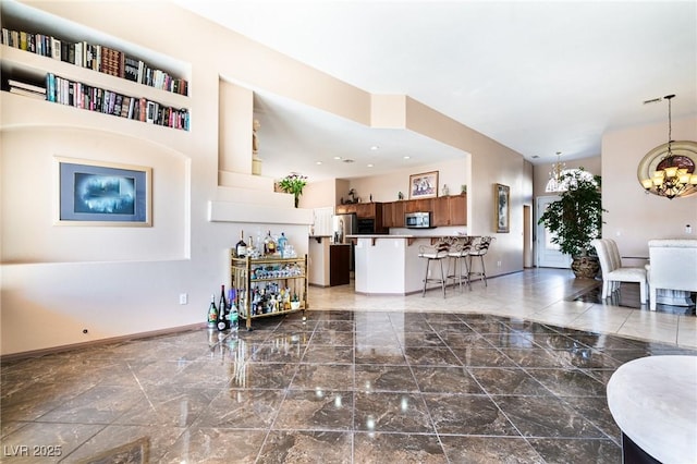 living area with baseboards, marble finish floor, and an inviting chandelier