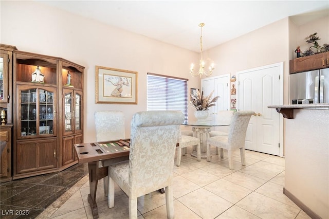 dining space with an inviting chandelier and baseboards