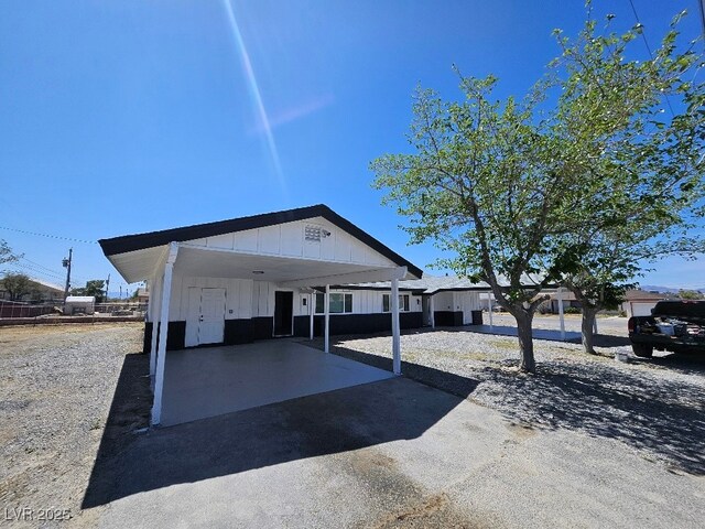 view of front of house featuring board and batten siding and aphalt driveway