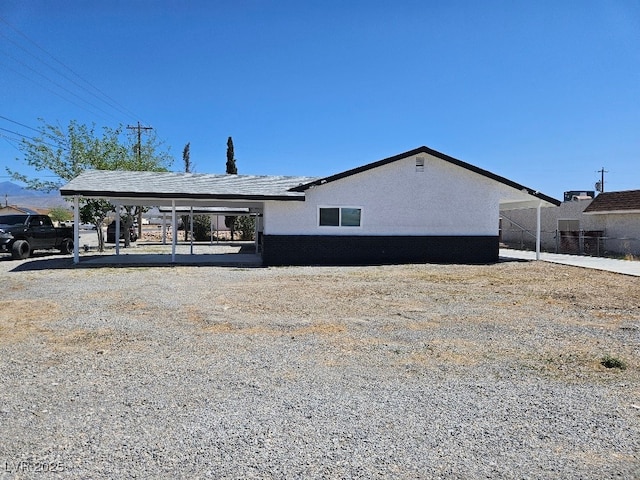 exterior space featuring a carport and stucco siding