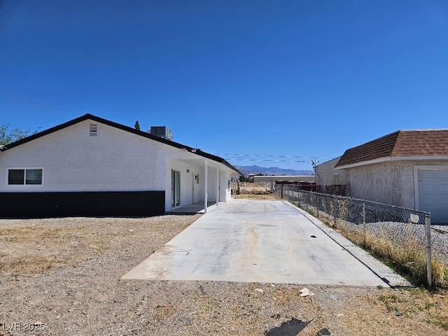 view of home's exterior featuring fence, a patio, and stucco siding