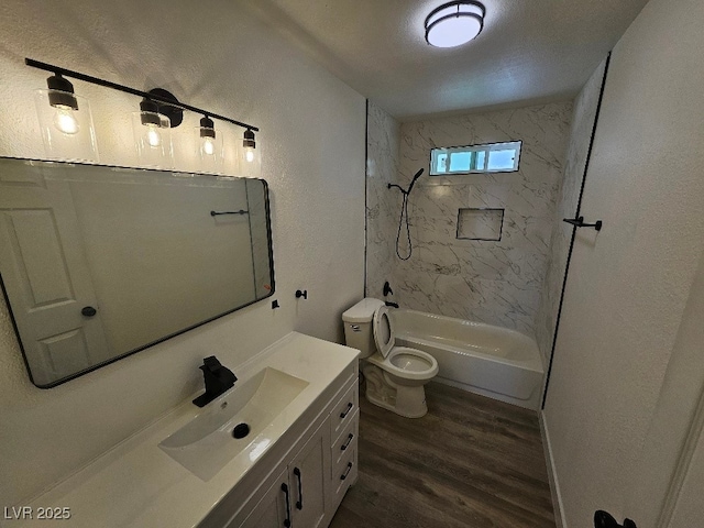 full bath featuring toilet,  shower combination, wood finished floors, and vanity