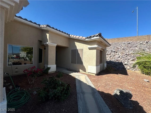 3567 Cottage Stream Ct, Laughlin, NV 89029 - property entrance with stucco siding and a tile roof
