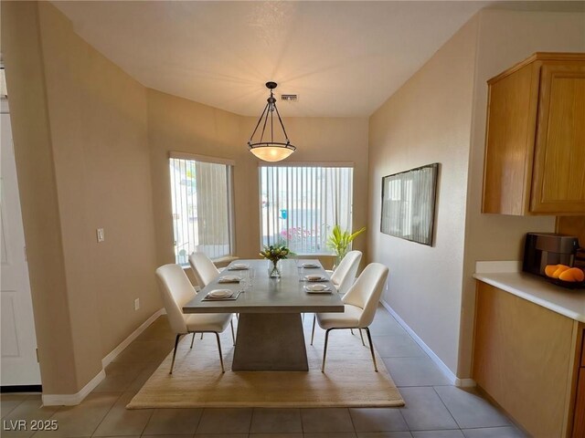 dining room with baseboards, visible vents, and light tile patterned floors