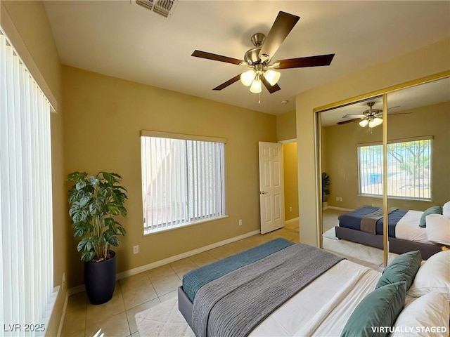 bedroom featuring baseboards, visible vents, a closet, and light tile patterned flooring