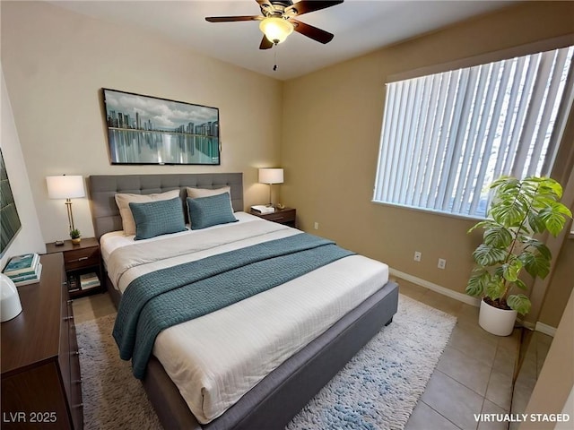bedroom featuring baseboards, tile patterned flooring, and ceiling fan