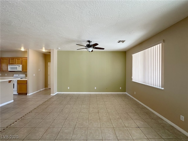 unfurnished living room featuring visible vents, a ceiling fan, light tile patterned floors, baseboards, and a textured ceiling