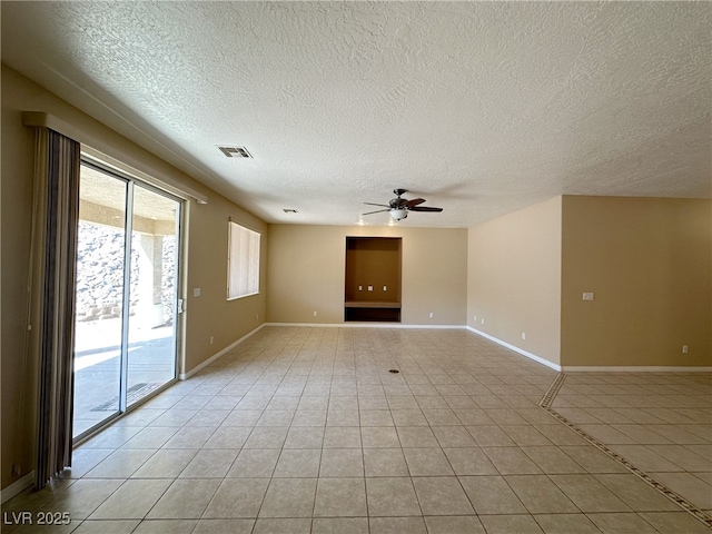unfurnished room featuring a ceiling fan, a textured ceiling, light tile patterned floors, baseboards, and visible vents