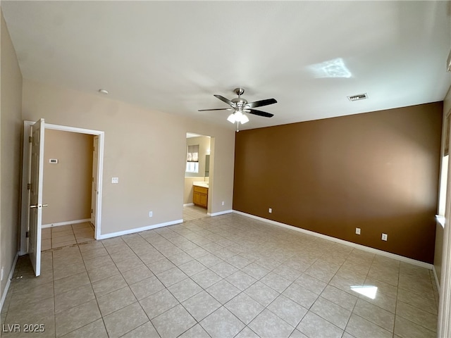 unfurnished room with visible vents, baseboards, ceiling fan, and light tile patterned floors