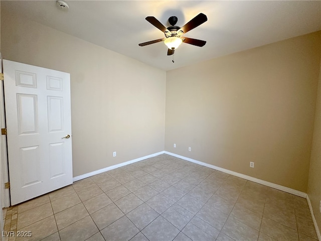 unfurnished room featuring a ceiling fan, baseboards, and light tile patterned floors