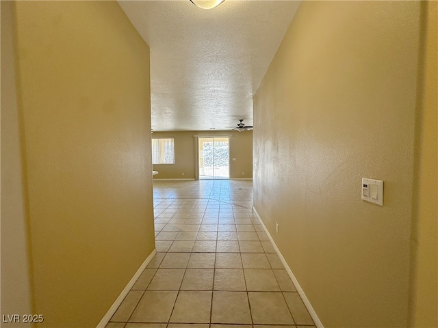 3567 Cottage Stream Ct, Laughlin, NV 89029 - hallway with baseboards, light tile patterned floors, and a textured ceiling