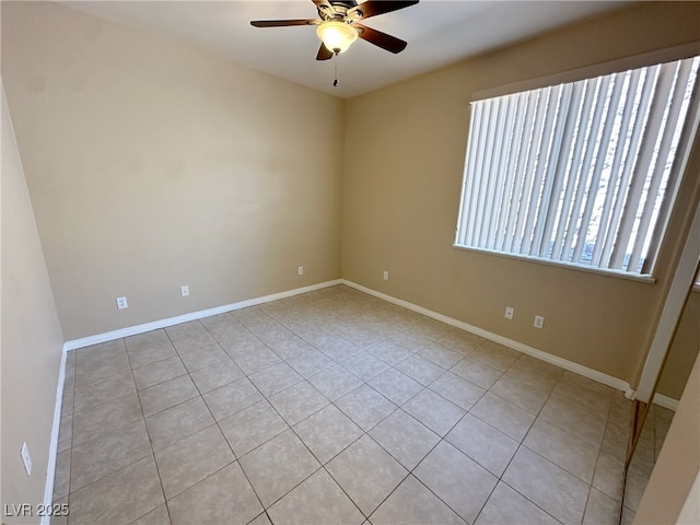 empty room featuring a ceiling fan, baseboards, and light tile patterned floors
