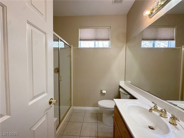 bathroom with a shower stall, a healthy amount of sunlight, tile patterned floors, and vanity