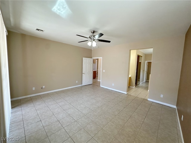 empty room featuring visible vents, a ceiling fan, baseboards, and light tile patterned floors