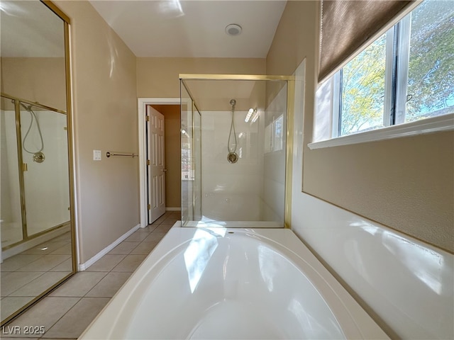 bathroom with a garden tub, tile patterned floors, and a stall shower