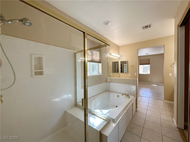 full bath with a garden tub, tile patterned floors, a stall shower, baseboards, and visible vents