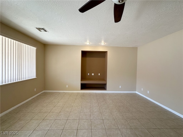 3567 Cottage Stream Ct, Laughlin, NV 89029 - spare room featuring ceiling fan, a textured ceiling, light tile patterned floors, and baseboards