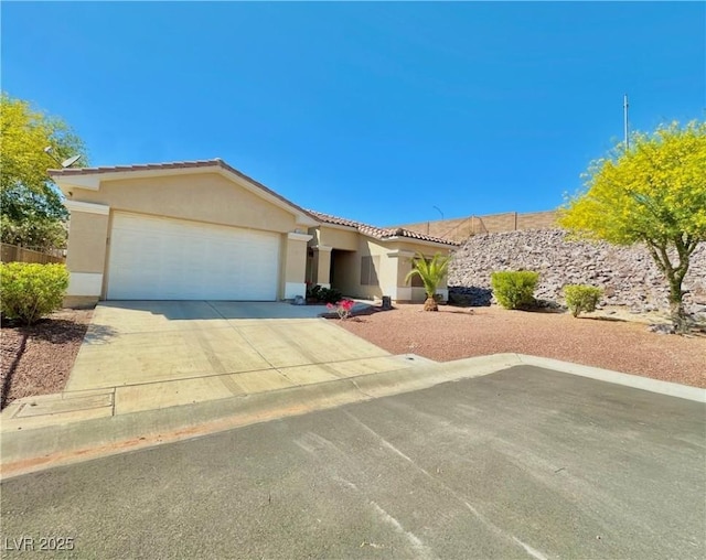 ranch-style house with stucco siding, an attached garage, driveway, and a tile roof